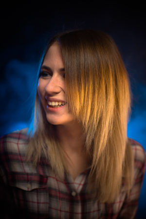 portrait smiling girl on blue background in studio.の写真素材