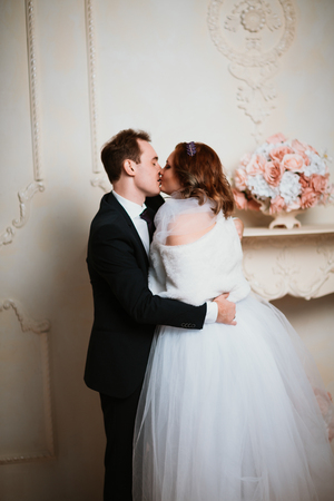 young bride and groom couple in a bright studio photo.の写真素材