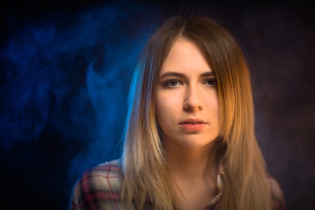 portrait smiling girl on blue background in studio.の写真素材