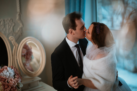 young bride and groom couple in a bright studio photo.の写真素材