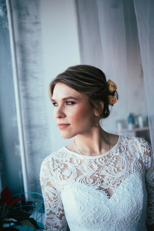 portrait of a bride near a window studio.の写真素材