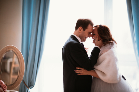 young bride and groom couple in a bright studio photo.の写真素材