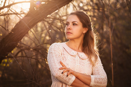 portrait of a girl in a field on a sunset background.の写真素材