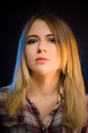 portrait smiling girl on blue background in studio.の写真素材