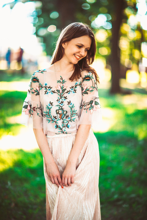 Beautiful young girl on a nature background.の写真素材