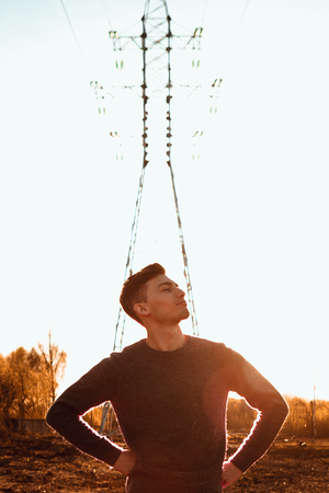 portrait of a guy in the field on a sunset background.の写真素材