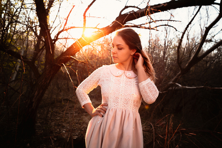 portrait of a girl in a field on a sunset background.の写真素材