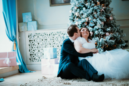 young bride and groom couple in a bright studio photo.の写真素材