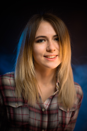 portrait smiling girl on blue background in studio.の写真素材