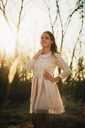 portrait of a girl in a field on a sunset background.の写真素材