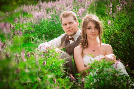 bride and groom portrait on the background of a mountain and grass.の写真素材