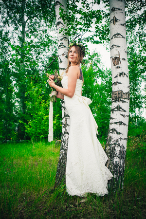Young bride near birches in the forest.の写真素材