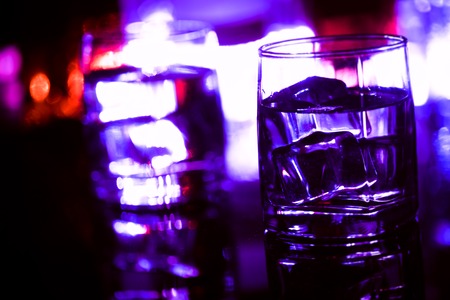 colored lighting of glasses in the night club bar.の写真素材
