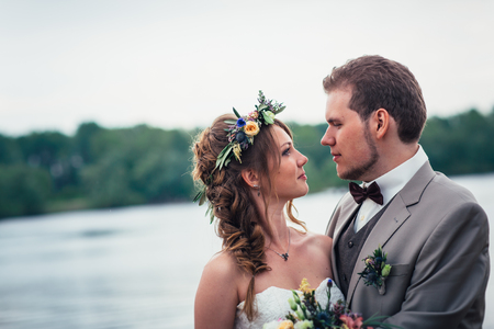 young couple in the style of provence on background of river.の写真素材