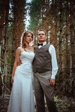 bride and groom in the forest of firs.の写真素材