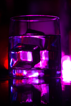 colored lighting of glasses in the night club bar.の写真素材