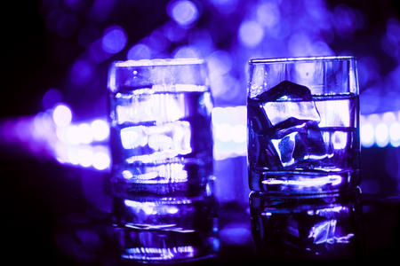 colored lighting of glasses in the night club bar.の写真素材