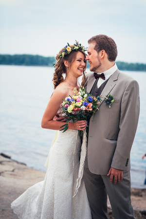 young couple in the style of provence on background of river.の写真素材