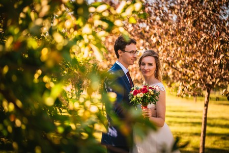 Beautiful stylish bride and groom on garden background.の写真素材