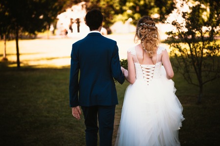 Beautiful stylish bride and groom on garden background.の写真素材
