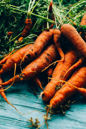 lot of carrots on a wooden background.の写真素材