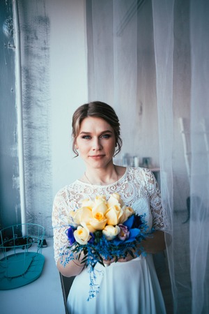 portrait of a bride near a window studio.の写真素材