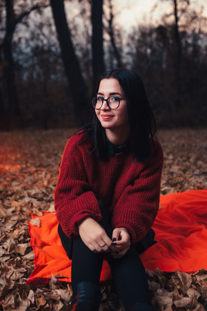 Girl in autumn forest, nature backgroundの写真素材