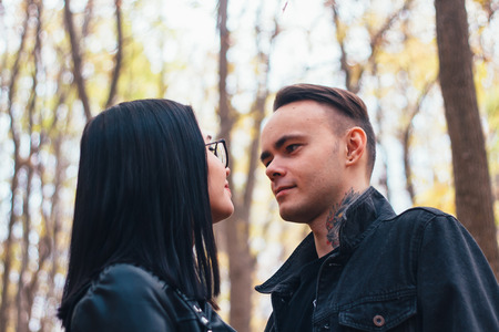 portrait of a young woman and a man walking in the autumn forest.の写真素材