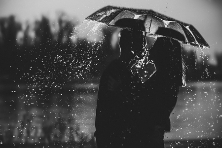 couple under an umbrella in the rain.の写真素材