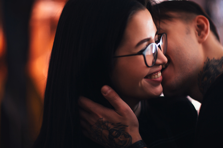 guy and the girl kiss closeup on a light backgroundの写真素材