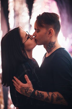 guy and the girl kiss closeup on a light backgroundの写真素材