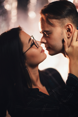 Couple in fashionable clothes on a shiny background.の写真素材