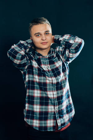portrait of a young man on a dark background.の写真素材