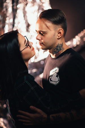 Couple in fashionable clothes on a shiny background.の写真素材