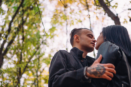 portrait of a young woman and a man walking in the autumn forest.の写真素材