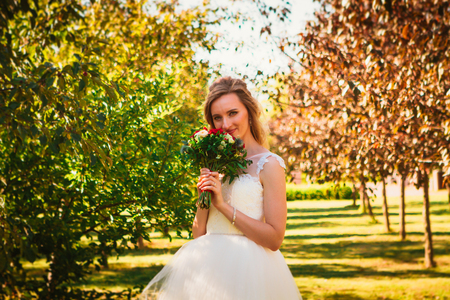 happy young bride on autumn forest background.の写真素材
