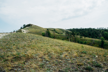 landscape of mountains and grass against the sky.の写真素材