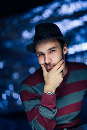 portrait of a guy in a hat on a blurred background.の写真素材
