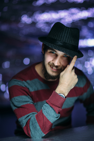 portrait of a guy in a hat on a blurred background.の写真素材