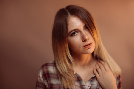 portrait smiling girl on orange background in studio.の写真素材