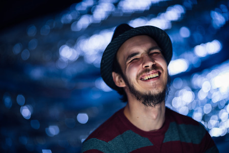 portrait of a guy in a hat on a blurred background.の写真素材