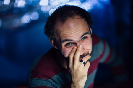 portrait of a guy in a hat on a blurred background.の写真素材