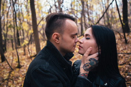 portrait of a young woman and a man walking in the autumn forest.の写真素材