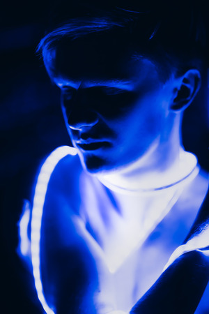 Portrait man Strip Light LED tape on dark color background.の写真素材