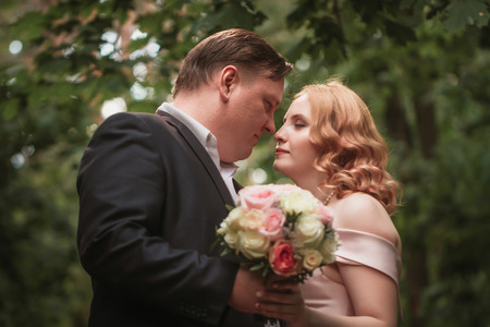 bride and groom dancing in the forest background and sunlight.の写真素材