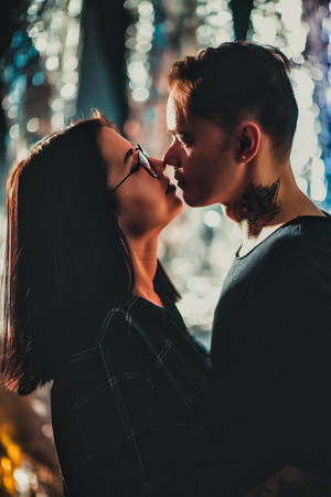 Couple in fashionable clothes on a shiny background.の写真素材