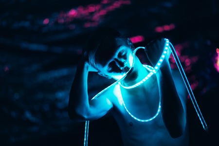 Portrait man Strip Light LED tape on dark color background.の写真素材
