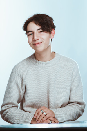 portrait of a teenager brunette guy in a studio.の写真素材