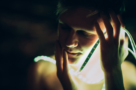 Portrait man Strip Light LED tape on dark color background.の写真素材