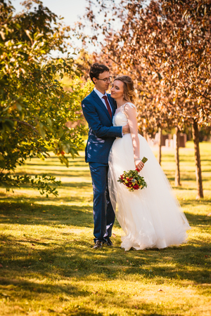 Beautiful stylish bride and groom on garden background.の写真素材